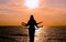 Indian dance silhouette on beautiful beach during sunset.