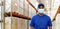 Indian delivery man in medical mask at warehouse