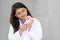 Indian dentist woman holding jaw model and toothbrush. Young and kind doctor demonstrating right way to clean teeth and gums by