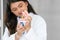 Indian dentist woman holding jaw model and toothbrush. Young and kind doctor demonstrating right way to clean teeth and gums by