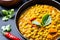 Indian Dhal spicy curry in bowl, spices, herbs, rustic black background. Generative AI