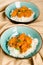 Indian dish - Chicken tikka masala served with rice and garnished with cilantro leaves