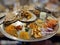 Indian dish with various chatnis,fried garlic, cucumber,bhakri,chapati, pickle,onion slices, carrot,lemon, papad, green chutney