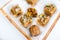 Indian Diwali sweets made from walnut kernels in glass dish on white background