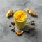 Indian drink turmeric golden milk in glass. Golden latte on light background ingredients for cooking