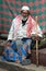 Indian elderly man sitting on step in Bangalore