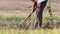 An Indian farmer digging in the field with the help of a shovel