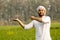 Indian farmer with empty hand for product putting and pointing finger at empty hand
