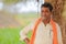 Indian farmer at green corn field