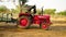 Indian farmer riding tractor with fully loaded trolley with organic fertilizer. Field preparation for new crop