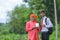 indian farmer showing agro product bottle with agronomist