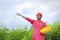 Indian farmer spreading fertilizer in the green banana field