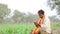 Indian farmer using mobile phone at corn field