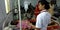 An indian female nurse staff adjusting glucose bottle liquidity speed during treatment