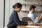 Indian female office employee sit in coworking working on computer