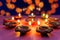 Indian festival Diwali, Diya oil lamps lit on colorful rangoli. Hindu traditional. Happy Deepavali. Copy space for text