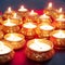 Indian festival Diwali, Diya oil lamps lit on colorful rangoli. Hindu traditional. Selective focus