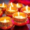 Indian festival Diwali, Diya oil lamps lit on colorful rangoli. Hindu traditional. Selective focus