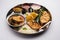 Indian Fish Platter or seafood Thali served in a steel plate or over banana leaf