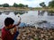 indian fisher kids hunting with bow arrow on river in India January 1, 2020