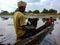 indian fisher man holded laptop on boat ride in India January 2020