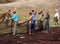 Indian fishermen are laying out on the ground fishing nets for drying