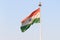 Indian flag flying against blue sky background. The National Flag of India is a horizontal rectangular tricolor saffron, white