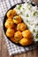 Indian food: Dum aloo potatoes in a sauce with rice close-up. vertical top view