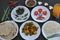 Indian Food: Flat lay of mushroom soup, saag greens, salad, chapati Indian bread, matar paneer mix veg, chawal rice