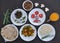 Indian Food: Overhead view of mushroom soup, saag greens, salad, roti Indian flat bread, matar paneer mix veg, chawal rice