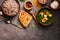 Indian food Palak Paneer , naan bread, rice and spices on a dark background. Overhead view,copy space