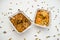 Indian food, pies, subhadra and mithai, foil plates on white background, with seeds, cinnamon, two forks inside plates