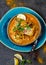 INDIAN FOOD. Traditional KERALA FISH CURRY with naan bread, gray plate, black background