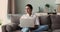 Indian freelancer sit on sofa with laptop working at home