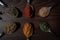 Indian Garam masala powder in bowl and it`s ingredients colourful spices. Served over moody background. selective focus