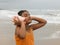 Indian girl listening to a conch