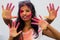 Indian girl showing her colourful hands printing or playing holi festival with colours, isolated white background.Young girl plays