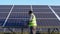 Indian handyman cleaning solar panels on station