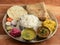 Indian Hindu Veg Thali / food platter consists variety of veggies, lentils, sweet dish, snacks etc., selective focus