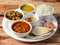 Indian Hindu Veg Thali / food platter consists variety of veggies, lentils, sweet dish, snacks etc., selective focus
