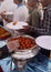 Indian Hindu volunteer serve the Gulab jamun,a sweet, to the devotee, in free distribution of prasad or food or meal in a temple