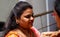 Indian Hindu woman apply Tilak on fore head of a devotee,a religious ritual,on Krisnastami festival celebration