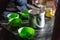 Indian horlicks powder in stainless steel bucket with green cups on the table in grocery store at Thangu and Chopta valley.