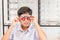 Indian kid boy with optometrist trial frame in ophthalmological clinic, Boy doing eye test checking examination with optometrist