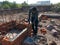 an indian labour fixing wall from cement material and bricks in India dec 2019