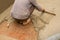 Indian labour leveling plasterred floor