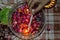 A indian lady lit up a jar is which is loaded with rose and candle on indian festival diwali deepawali with fire  on table