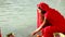 Indian Lady offering prayer on the bank of river Ganges.