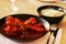 Indian lamb or mutton shank curry, also known as nalli rogan josh on dining table with jeera rice