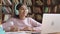 Indian latin school girl raising hand learning online on video call.